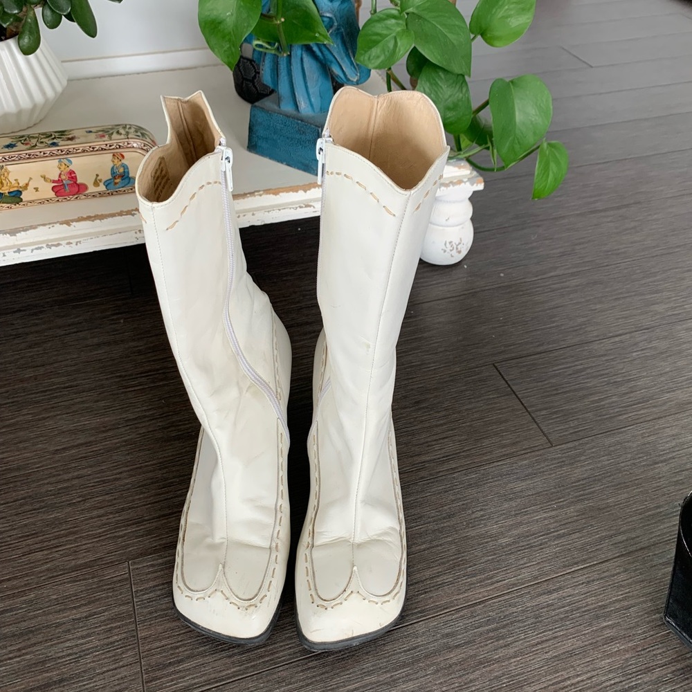 White John Fluevog boots with heart shaped heel.